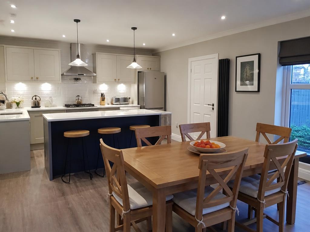 Same kitchen-dining room after redecoration with fresh paint and modern fittings